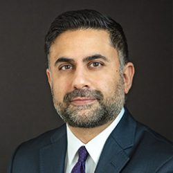 Headshot Dr. Javeed Sukhera in blue suit and tie