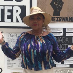 Photo of Lorraine Klassen infront of Black Lives Matter signs