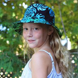 Photo of Lyla Wheeler outdoors wearing hat with leaf pattern
